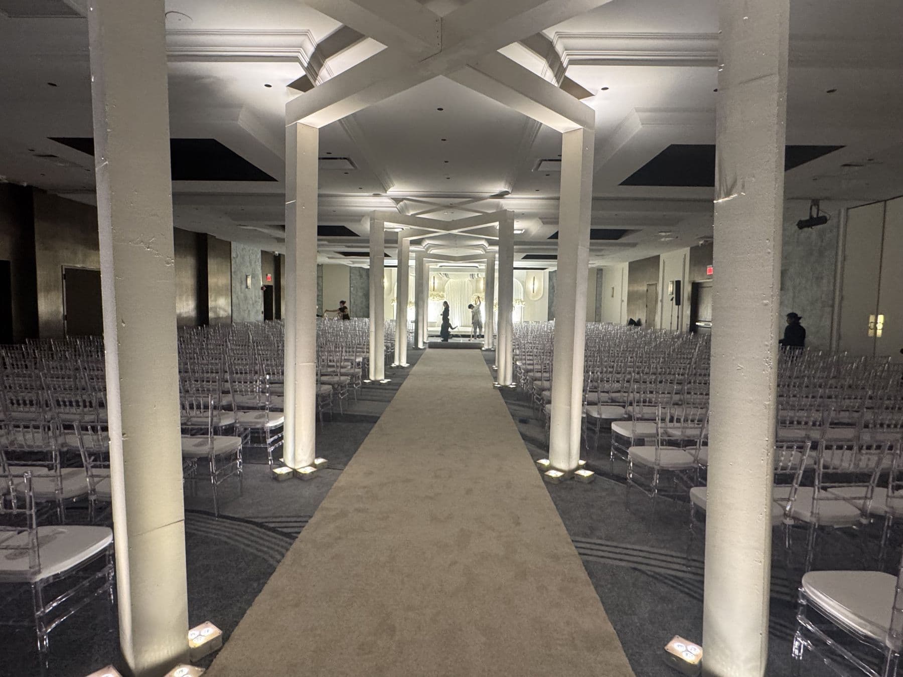 A ceremony aisle set between columns