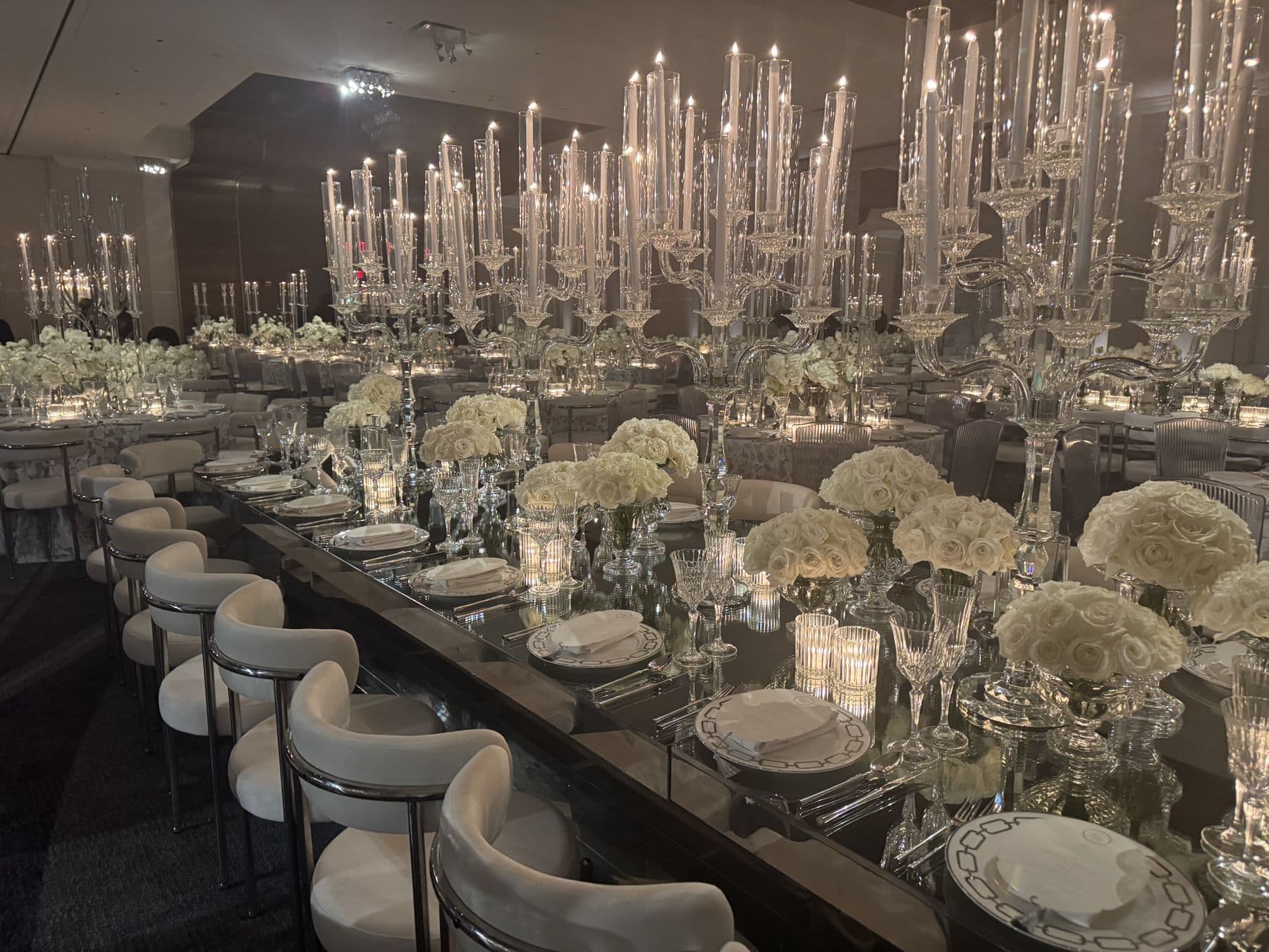 A candlelit long table set for a wedding